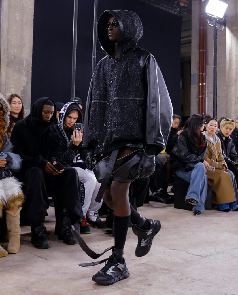 A model wearing Reebok x SONGZIO Premier Floatzig Shadow sneakers in the SONGZIO fashion show