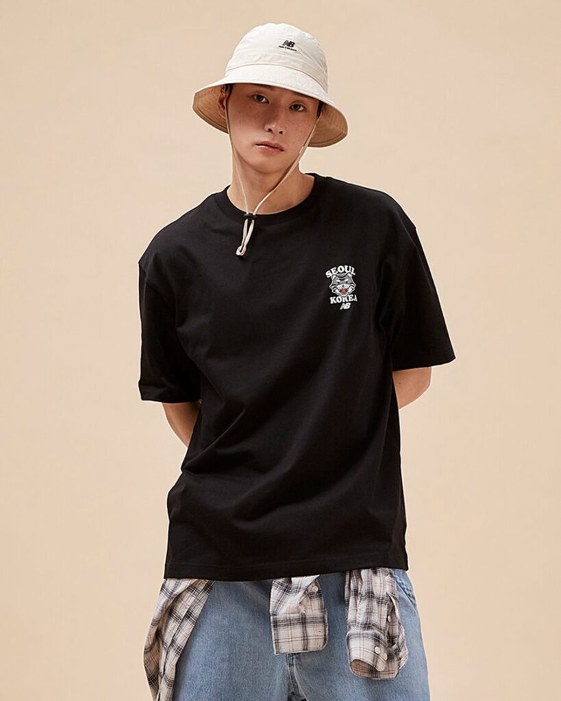 A male model wearing New Balance Seoul Tiger T-Shirts in Black color, an exclusive collection in South Korea
